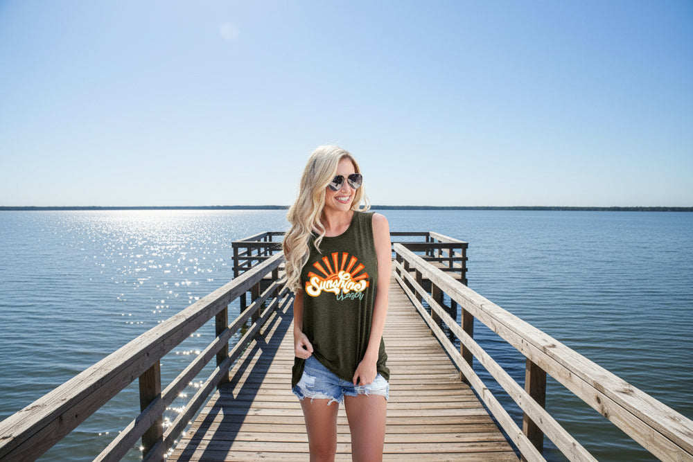 Woman wearing a green sleeveless shirt with 'Sunshine' text, sunglasses, and denim shorts on a white background